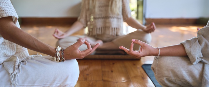 Three women practising yoga