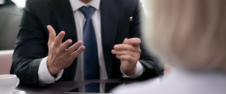 A businessman talking to an older women